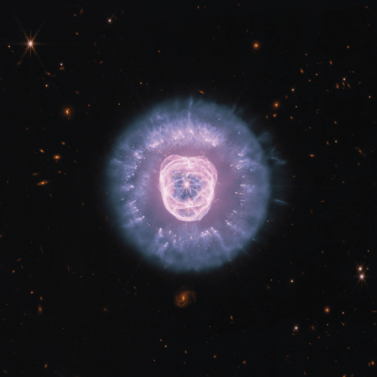 The Lion Nebula, a luminous planetary nebula against black space.
